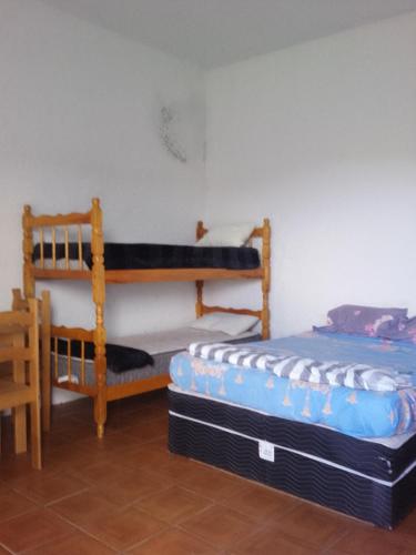 a bedroom with two bunk beds and a table at Paraíso chuí in Santa Vitória do Palmar