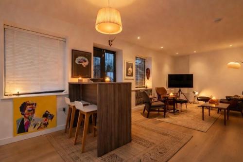 a living room with a table and chairs and a living room at cozy 1 bedroom flat in Soho in London
