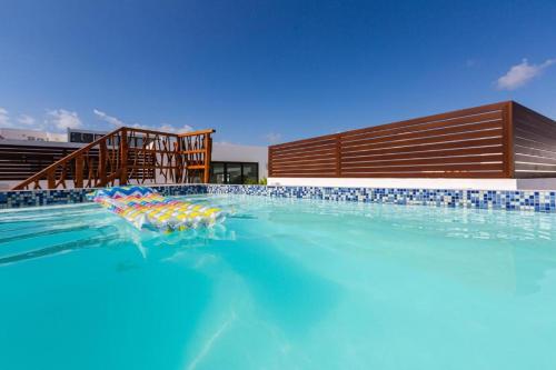 a pool with a bunch of umbrellas in the water at Ph and apartments riviera Maya in Playa del Carmen