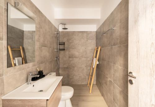 a bathroom with a sink and a toilet at Hillside Collection - by Hospirit in Mikonos