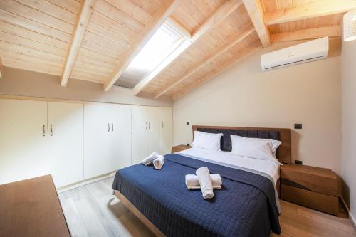 a bedroom with a large bed with towels on it at Kallistis Home in Kontokali