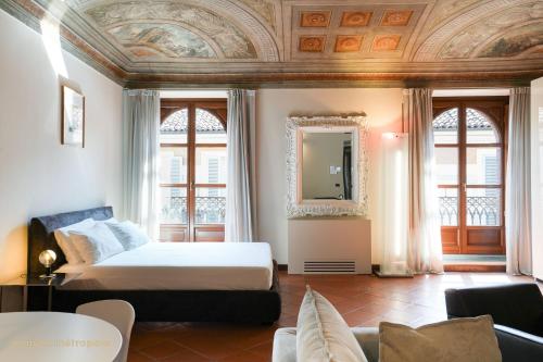 a bedroom with a bed and a mirror on the ceiling at Palazzo Zoya - Elegant Historic Suites - Asti Center - Near Langhe & Monferrato in Asti