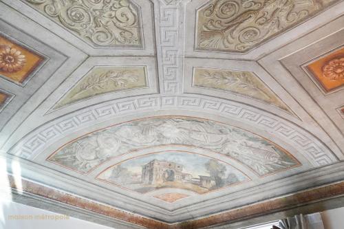 a ceiling in a building with paintings on it at Palazzo Zoya - Elegant Historic Suites - Asti Center - Near Langhe & Monferrato in Asti