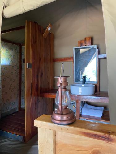 a room with a mirror and a scale on a table at Nature Lovers Camp in Sekenani