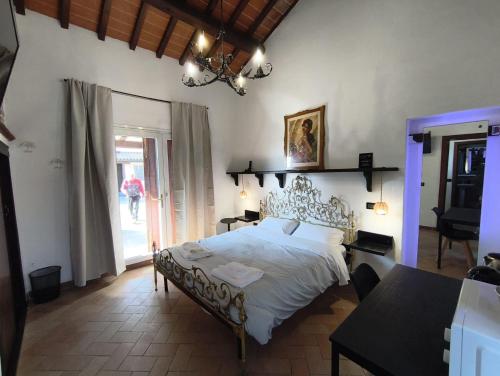 a bedroom with a large bed and a table at Il Quercetino di Momo in Ravenna