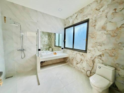 a bathroom with a sink and a toilet and a window at Villa luxurious in Koh Samui