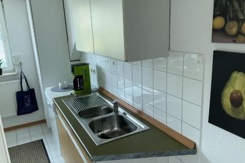 a kitchen counter with a sink in a kitchen at FewoConny in Hattstedt