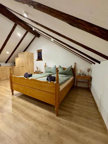 a bedroom with a wooden bed in a attic at Charmantes Rustico La Vedetta mit Terrasse in Minusio
