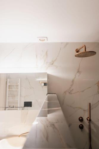 a white bathroom with a marble wall at Nafos Villa Stella in Levkákia