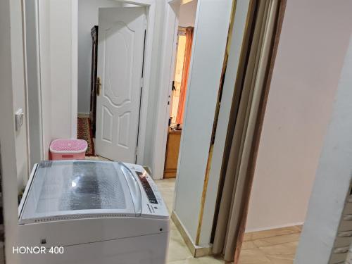 a room with a washing machine in front of a door at Hurghada Red Sea Apartments in Hurghada
