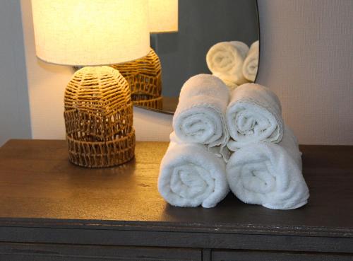 a pile of towels sitting on a table next to a lamp at Cranwell Court in Aberystwyth