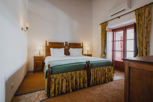 a bedroom with a bed and a window at Monte da Lapa in Arraiolos