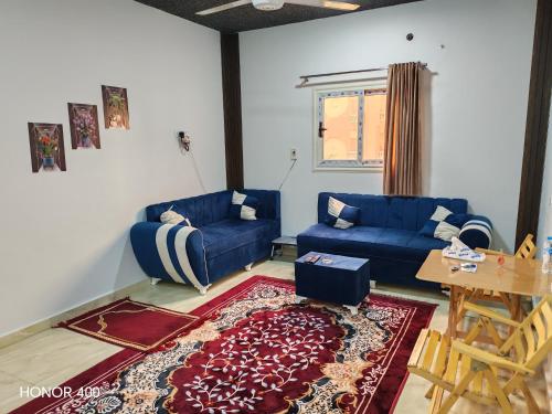 a living room with a blue couch and a table at Hurghada Red Sea Apartments in Hurghada