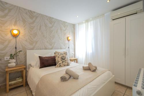 a bedroom with a large white bed with two pillows at L’Ancora Suite in Jávea