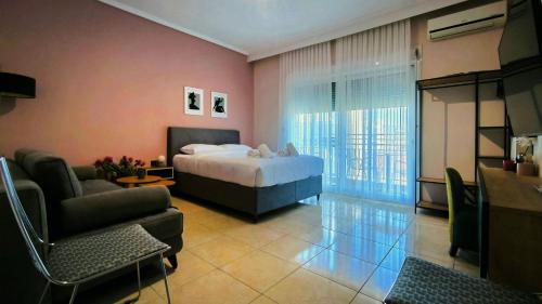 a bedroom with a bed and a living room at Gk Central Studio Xanthi in Xanthi