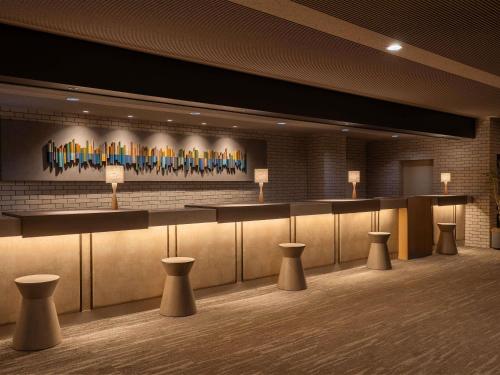 a lobby with a bar with stools in it at Mercure Urabandai Resort & Spa in Kitashiobara