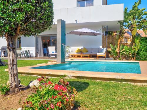 a swimming pool in the backyard of a house at Villa Serena in Mijas Costa