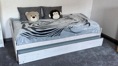 two stuffed animals are sitting on a bed at Ferienwohnung Irma in Malschwitz