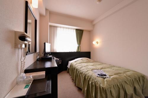Ένα ή περισσότερα κρεβάτια σε δωμάτιο στο Plaza Hotel Fujinoi