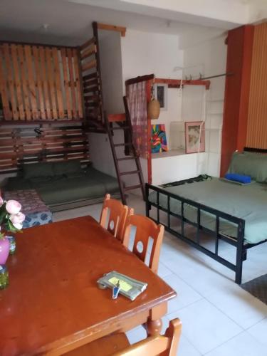 a room with two bunk beds and a table and chairs at Maraño's Home in Legazpi