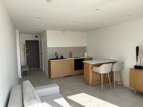 a kitchen with a couch and a table in a room at CentralPark Katowice in Katowice
