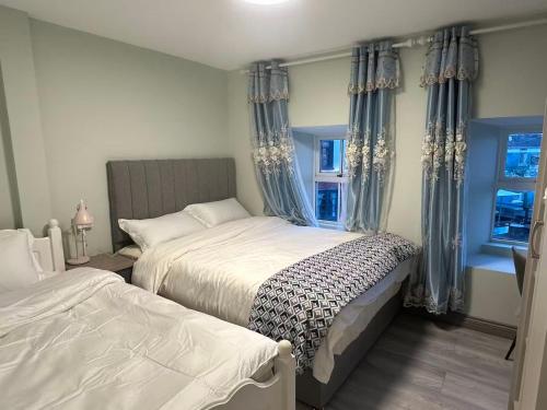 a bedroom with two beds and a window at Cove Guest Accommodation in Kinvara