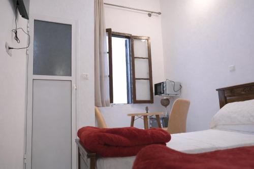 a bedroom with a bed and a window at Tangier city center 3 in Tangier