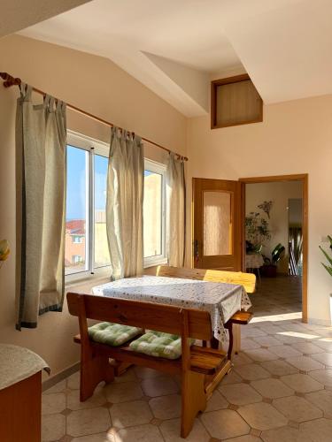 a bedroom with a bed and a large window at Apartments Robert in Tučepi