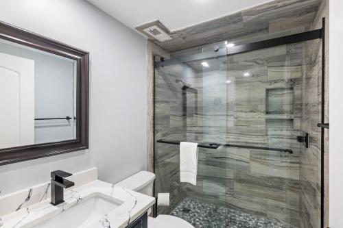 a bathroom with a shower and a toilet and a sink at 2371 Shipwatch Villa by Akers Ellis Rentals in Kiawah Island