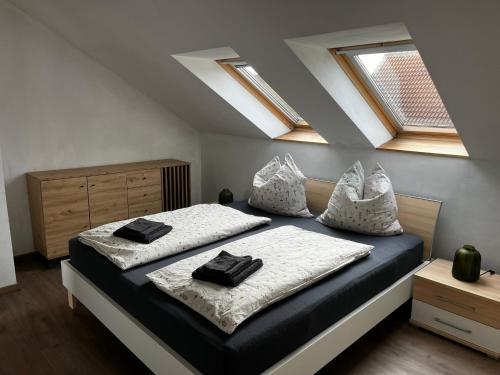 a bedroom with two beds and two skylights at Ferienwohnung Seeblick in Wustrow
