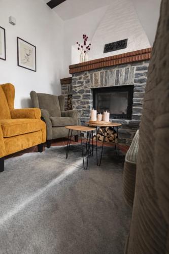 a living room with a couch and a fireplace at Zur Klapperburg in Zell an der Mosel