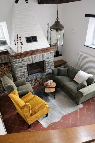 a living room with a couch and a fireplace at Zur Klapperburg in Zell an der Mosel