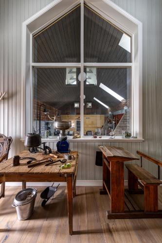 a kitchen with a table and a large window at Silfurberg in Þorgrímsstaðir