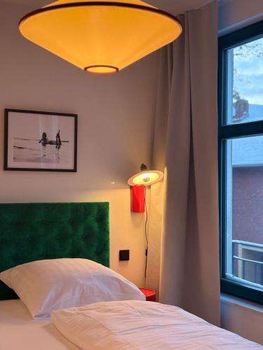 a bedroom with a bed and a large window at Hafen33 in Leer