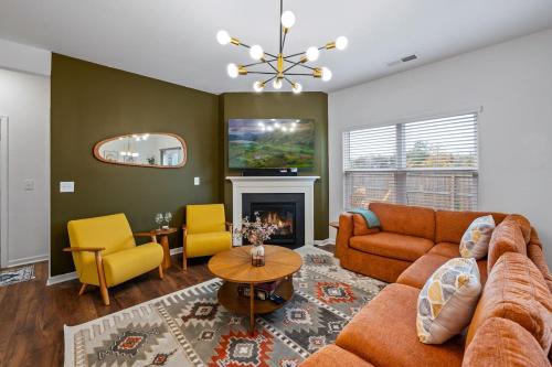 a living room with a couch and a fireplace at Spacious Farragut 5BR FamilyGroup Getaway near UT in Knoxville