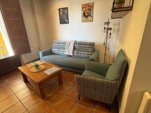 a living room with a couch and a table at Rascacielos San Martín in Cuenca