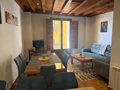 a living room with a table and chairs and a couch at Rascacielos San Martín in Cuenca