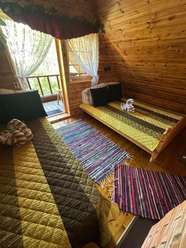 a room with two beds in a log cabin at Mõnus palkmaja Muhu mändide all in Nõmmküla
