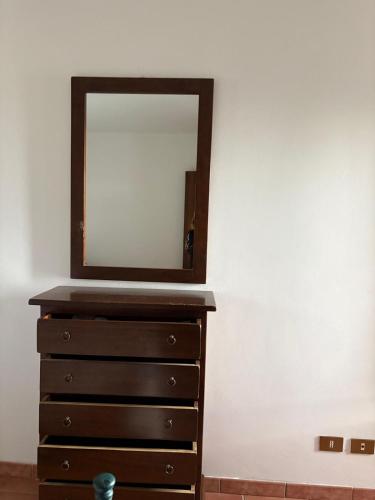 a dresser with a mirror on top of it at La Dimora del Molo in Fuscaldo