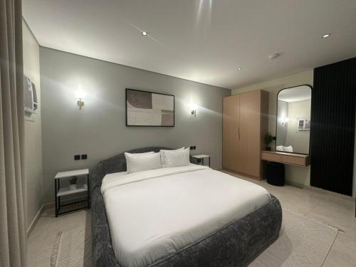 a bedroom with a large white bed and a mirror at Ambra 213 in Medina