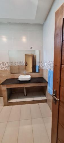 a bathroom with a sink and a mirror at Abbott royale farm in Abbottabad