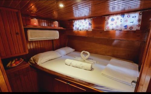 a small room with a bed with towels on it at Cakabey Yachting in Demre