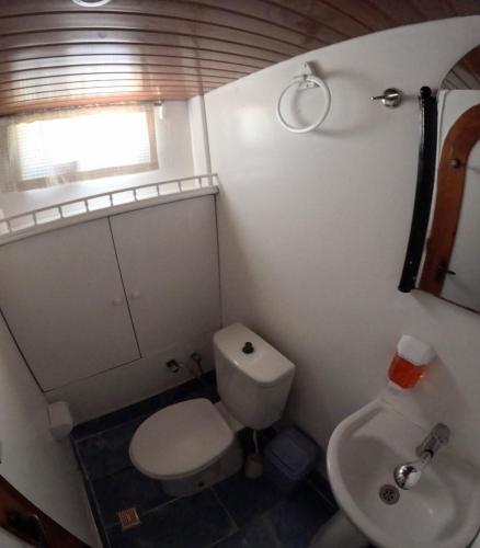 a small bathroom with a toilet and a sink at Cakabey Yachting in Demre