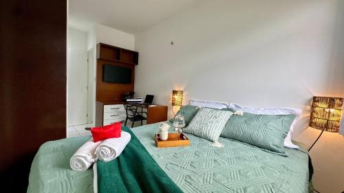 a bedroom with a green bed with towels on it at (103) Coastal seaside - Pebble in Pimenta