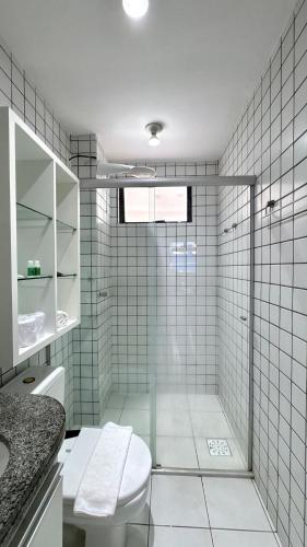 a bathroom with a shower with a toilet and a sink at (103) Coastal seaside - Pebble in Pimenta