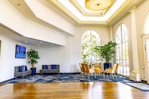 a room with a table and chairs and windows at La Quinta by Wyndham Sarasota Downtown in Sarasota