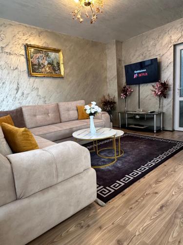 a living room with a couch and a tv at Christian Dior Lazarevac in Lazarevac