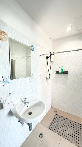 a white bathroom with a sink and a mirror at DANK Hotel 420 friendly Patong Phuket in Patong Beach