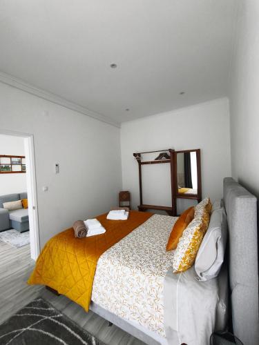 a bedroom with a bed and a couch at Casa Galante in Furnas