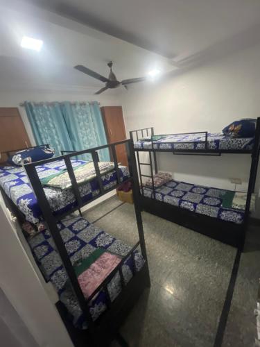three bunk beds in a room with a ceiling at BEYOND INFINITY GROUP, pg in Navi Mumbai